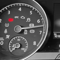 Cruscotto auto con spia del servosterzo accesa in rosso. Indica un problema con il sistema di assistenza alla guida.