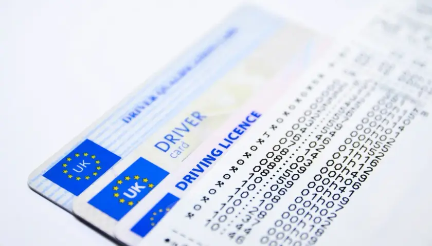 Patente di guida UK e un foglio con dati, forse una notifica tardiva ordinanza sospensione patente.